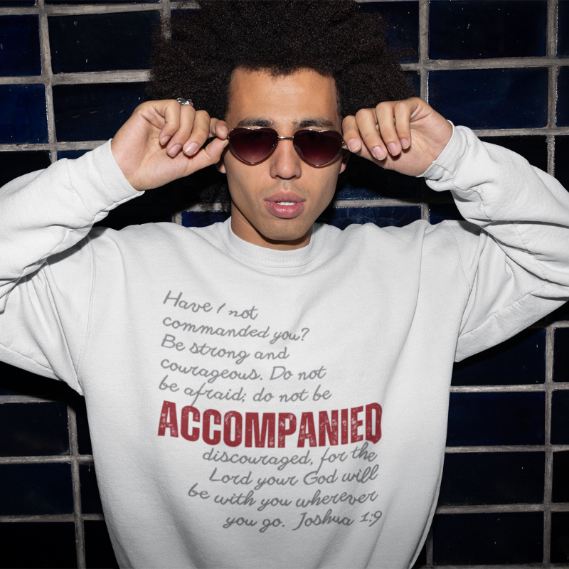 Model photo of a young man wearing a light grey crew sweatshirt from the Accompanied Collection