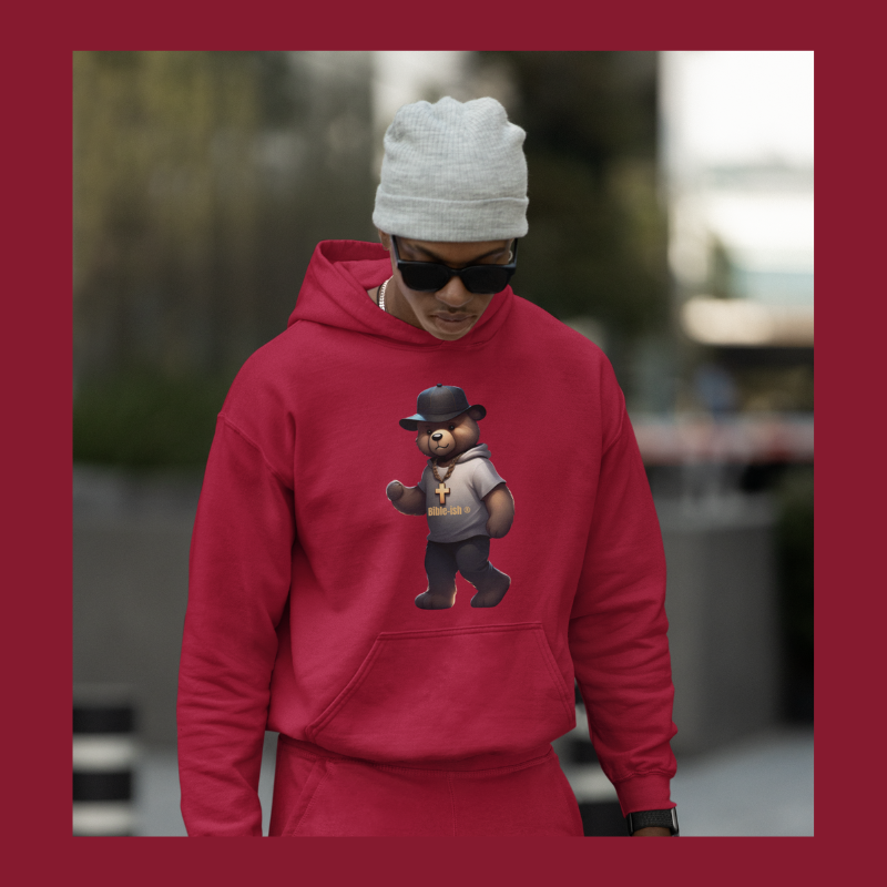 Man with a grey beanie and sunglasses walking down street with faithful teddy hoodie and joggers set in red