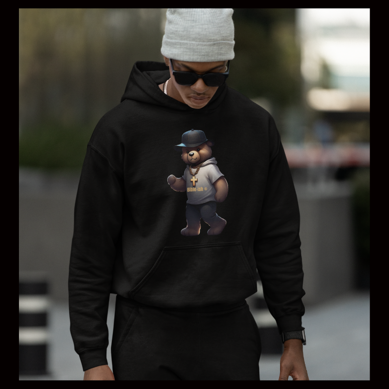Man in industrial park area wearing a beanie and black sunglasses and black hoodie and jogger set from faithful teddy edition