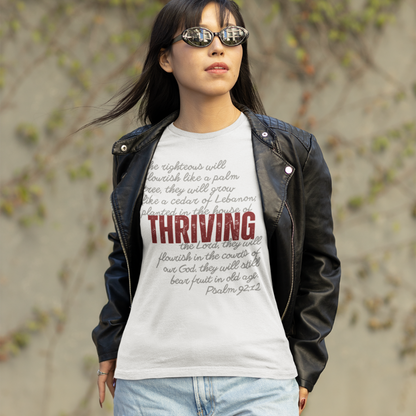 Young woman wearing black biker jacket over a white tee from the thriving collection