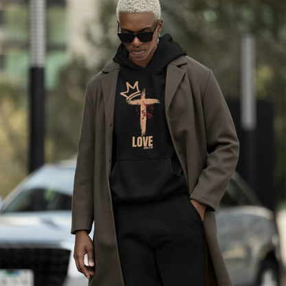 Man is wearing a black hoodie and jogger set from the Love Collection. The Design feature a crown, a cross and a deconstructed heart in red to represent the blood Jesus shed for us.